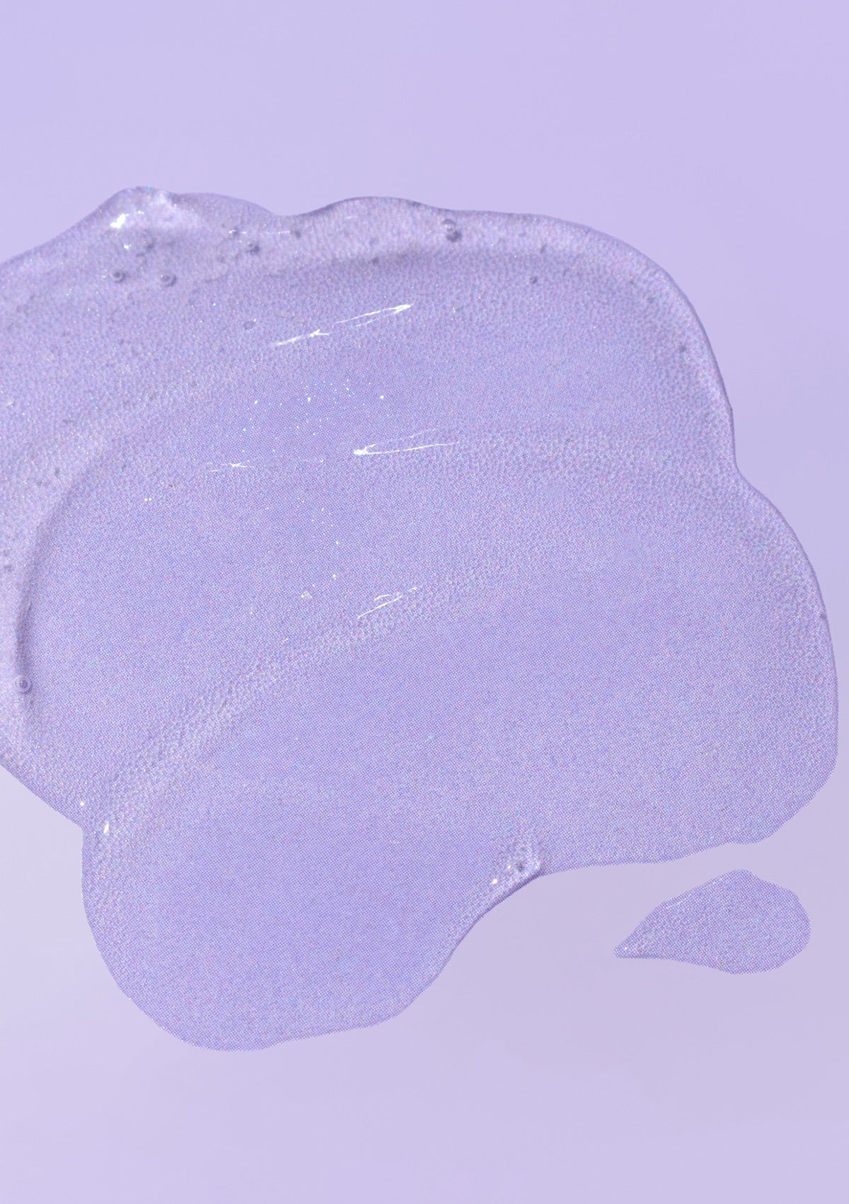 Textur des Hydrating Glow Exfoliant auf lilafarbigen Untergrund